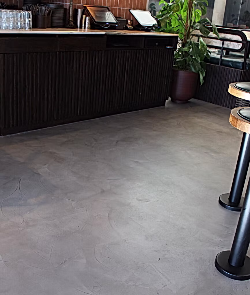 Contemporary commercial interior demonstrating seamless microcement surfaces